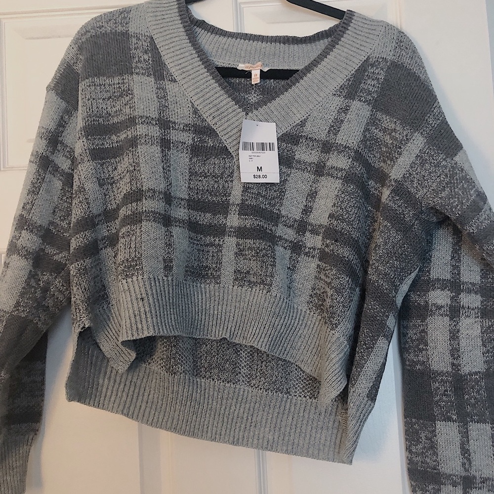 grey plaid v neck sweater.